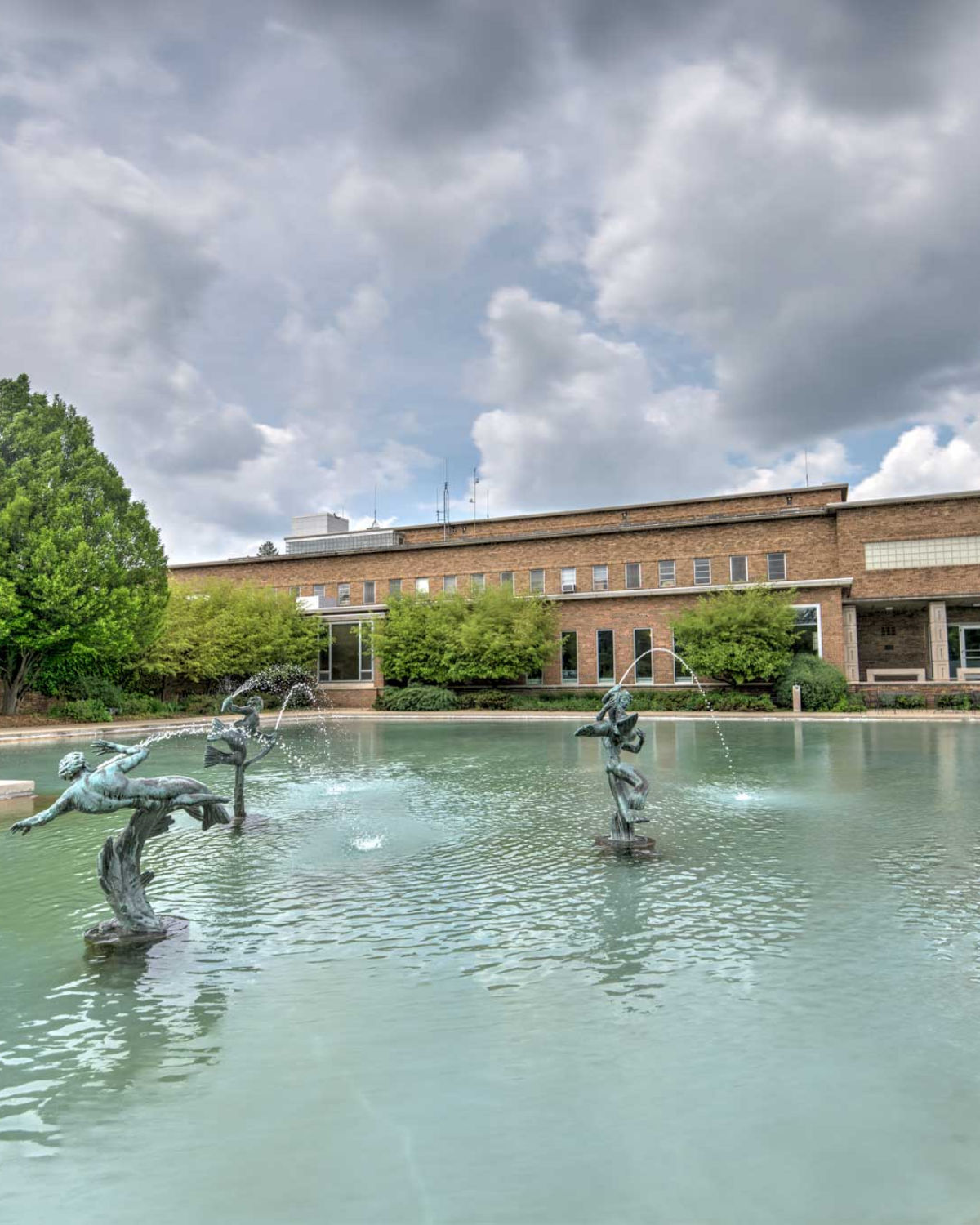 The elegant courtyard fountain and classical stone architecture of Cranbrook House and Gardens in Bloomfield Hills, Michigan