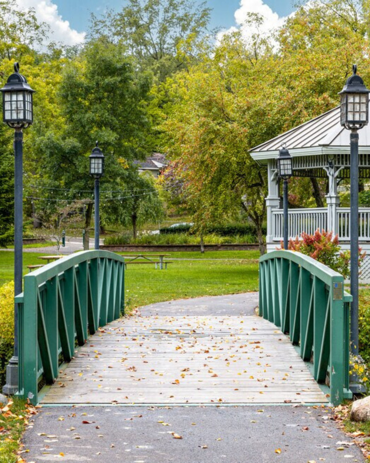 View of a small bridge and gazebo in Depot Park in Clarkston, MI