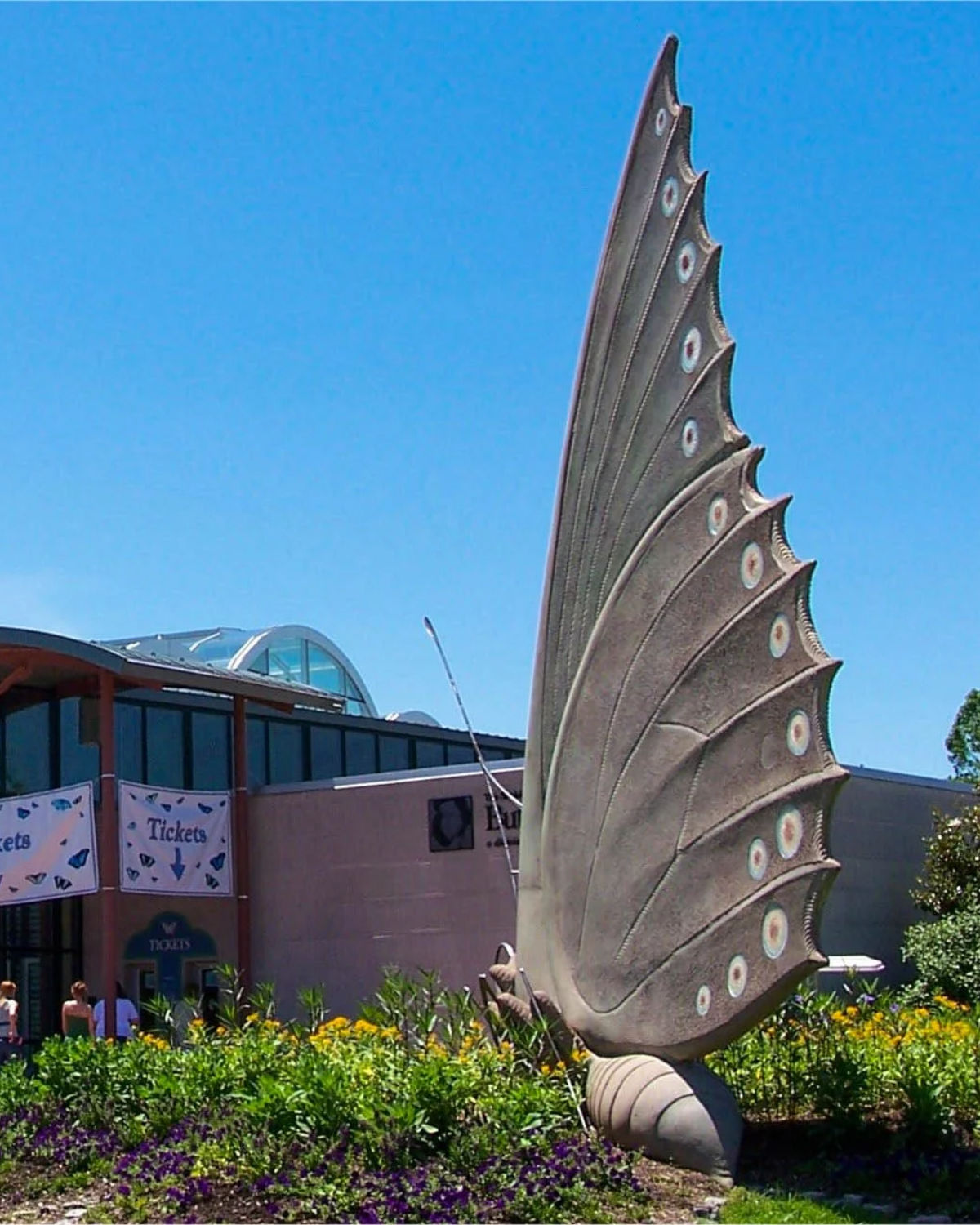 Close-up architectural detail of the dramatic curved steel fins of the Chesterfield Amphitheater against a bright blue sky in Chesterfield, Missouri