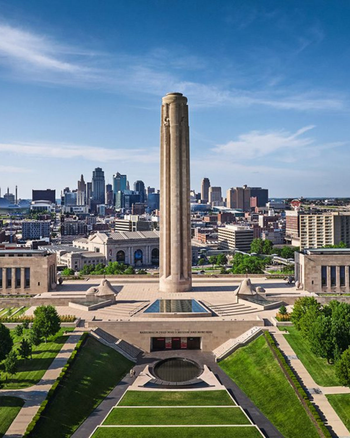 The Liberty Memorial tower soaring above the National WWI Museum and Memorial in Kansas City, MO with Union Station and the downtown skyline visible in the background