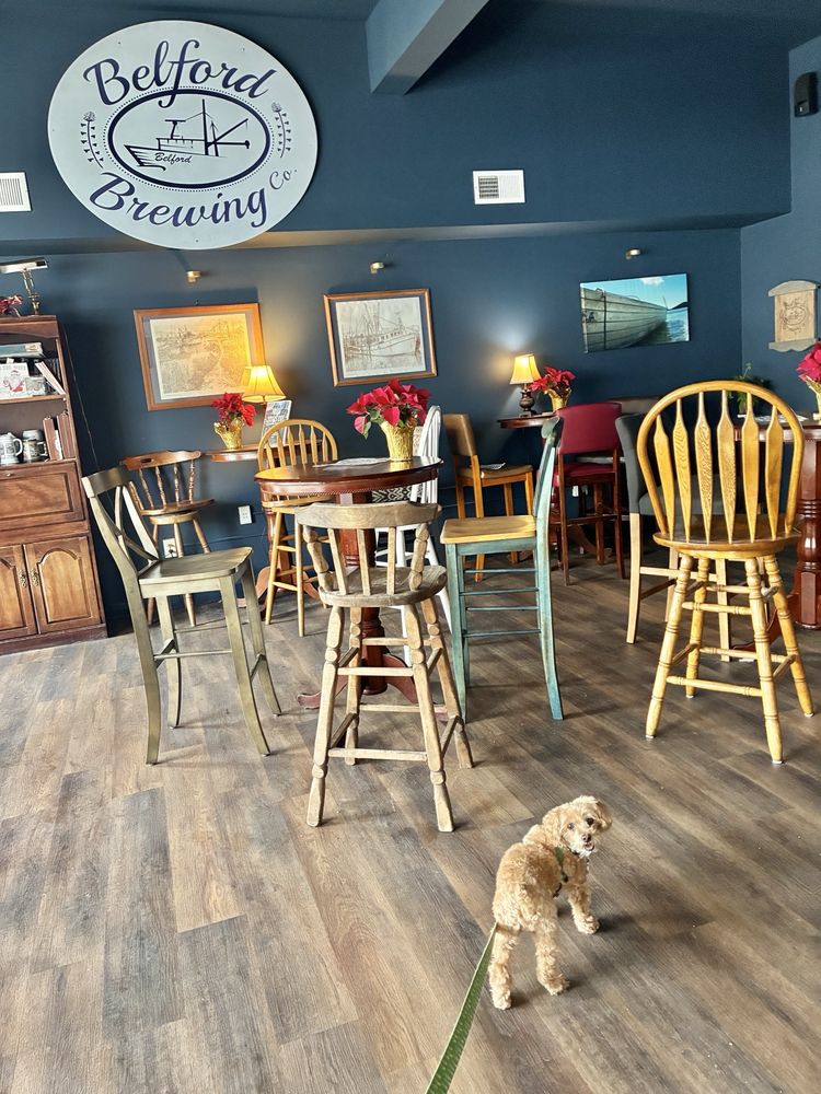 Interior of Belford Brewing Company in Belford, New Jersey, featuring brewery signage, wooden tables and chairs, local artwork, and a welcoming taproom.