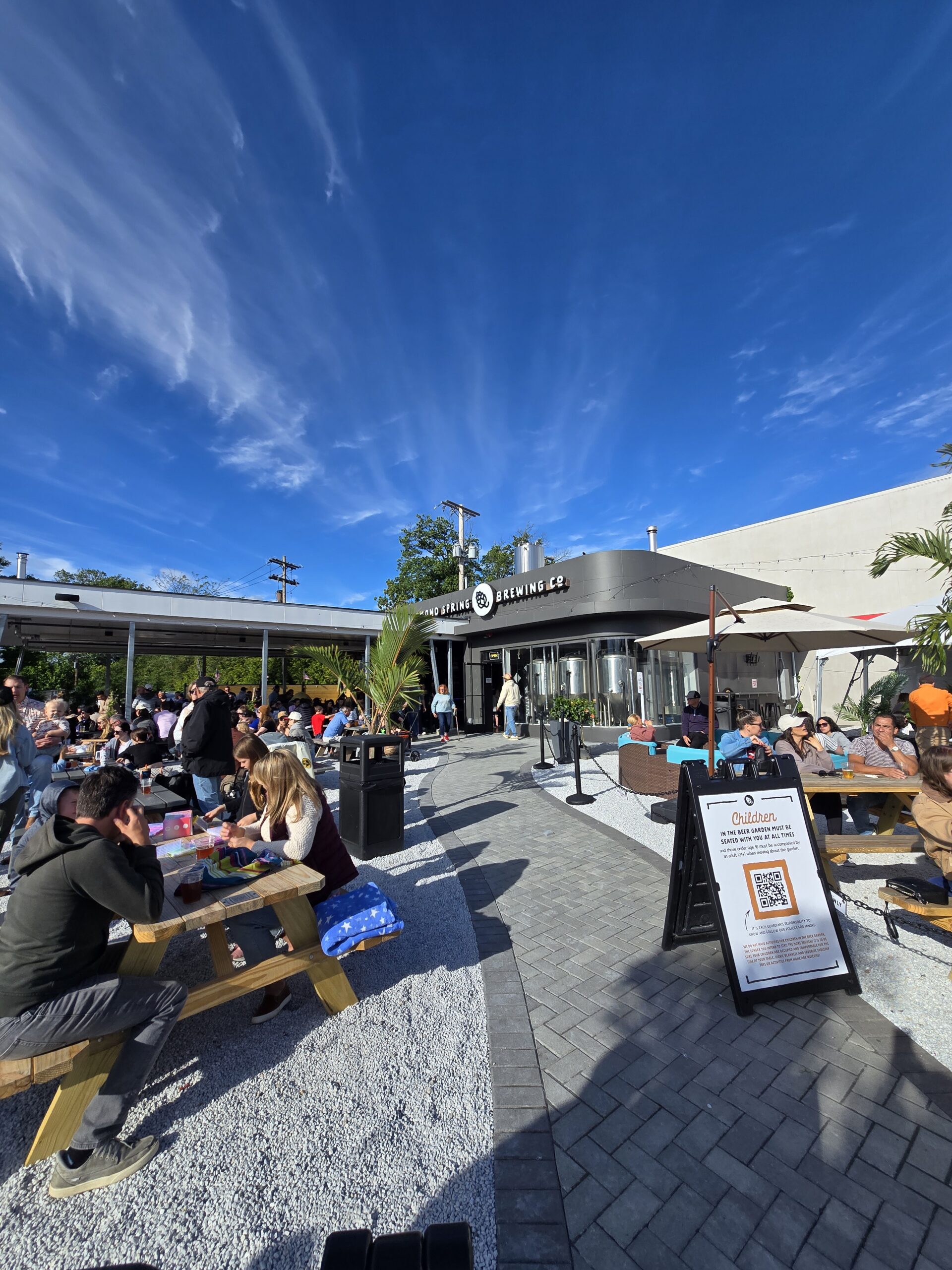 Guests enjoy outdoor seating at Diamond Spring Brewing Company in downtown Denville, New Jersey, on a sunny afternoon.
