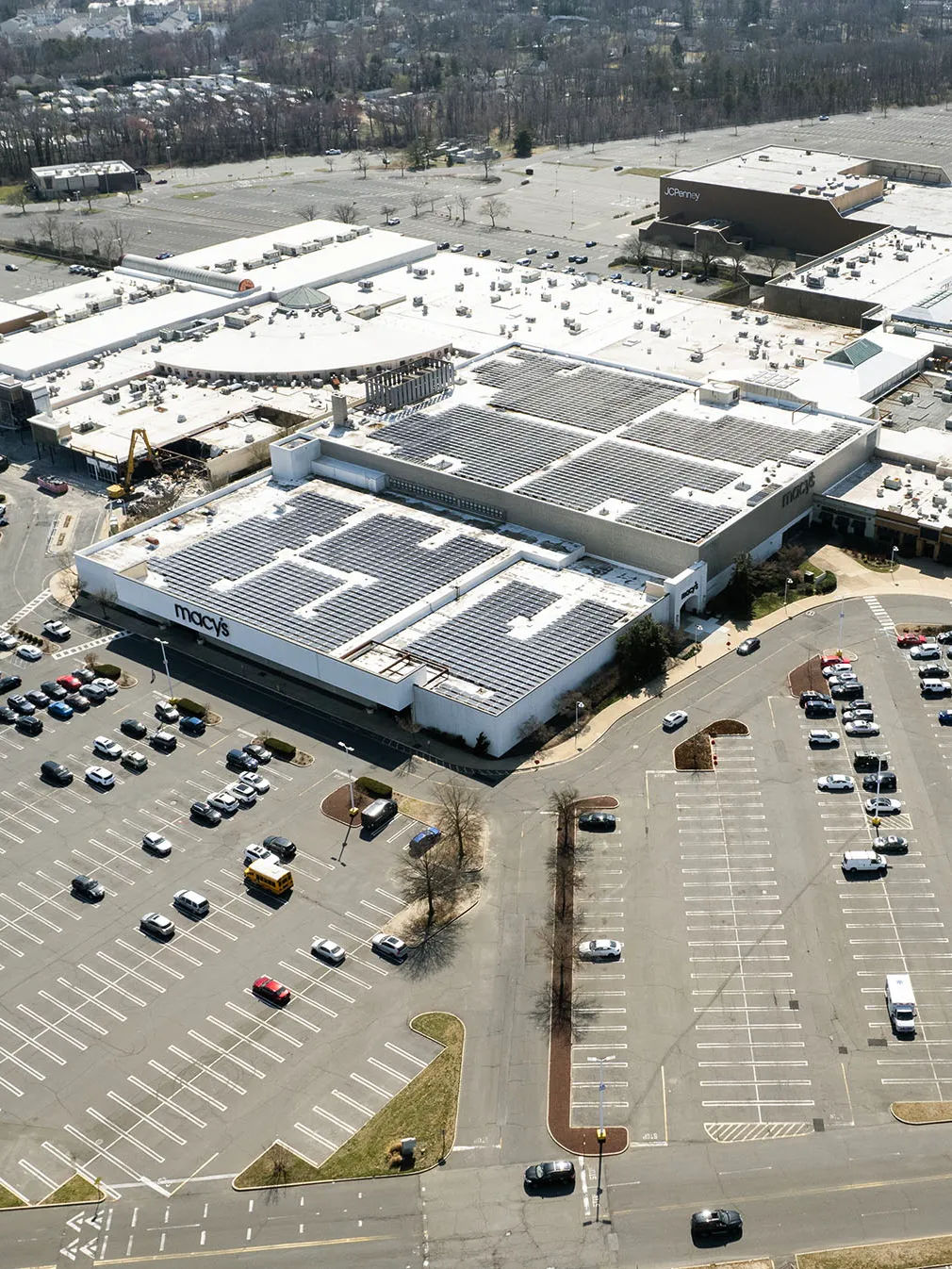 Monmouth Mall in Eatontown, New Jersey, viewed from above, showcasing the expansive shopping complex, surrounding parking areas, and major retail stores.