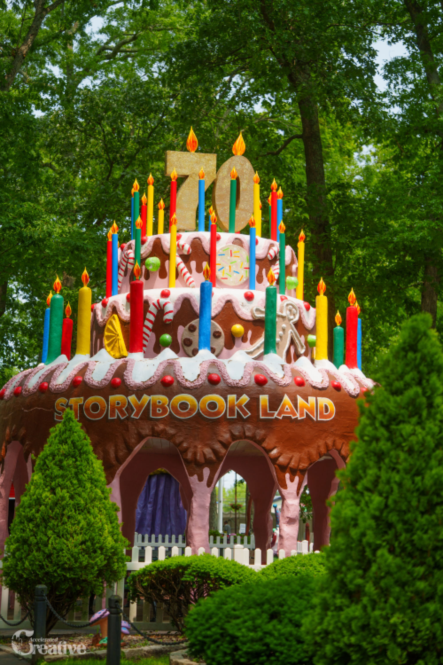 Giant birthday cake entrance display at Storybook Land, the family-owned children's theme park in Egg Harbor Township known for storybook-themed rides and attractions.