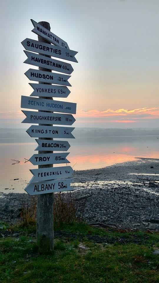 Scenic Hudson River directional sign near Haverstraw, New York, pointing toward Hudson Valley destinations including Manhattan, Beacon, Kingston, and Albany.