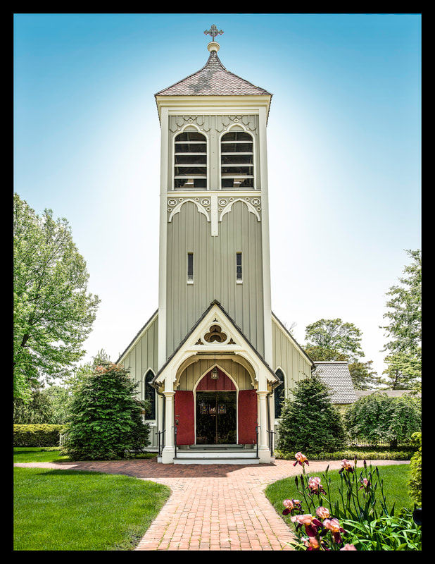 Historic church in Saint James, NY featuring a tall bell tower, Gothic-inspired architecture, landscaped grounds, and a brick walkway leading to the entrance on a sunny day.