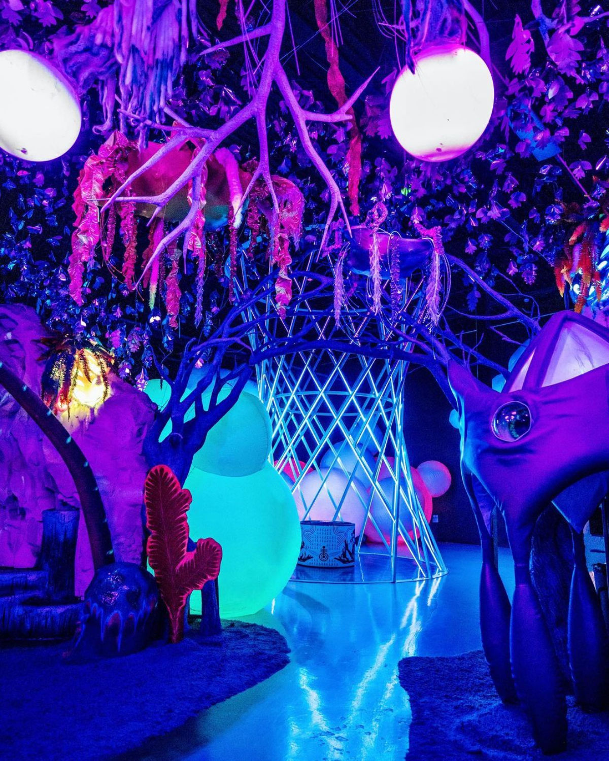 Immersive neon-lit interactive art installation with glowing purple and blue sculptural figures at Otherworld immersive art experience in Columbus, Ohio near Blacklick, OH