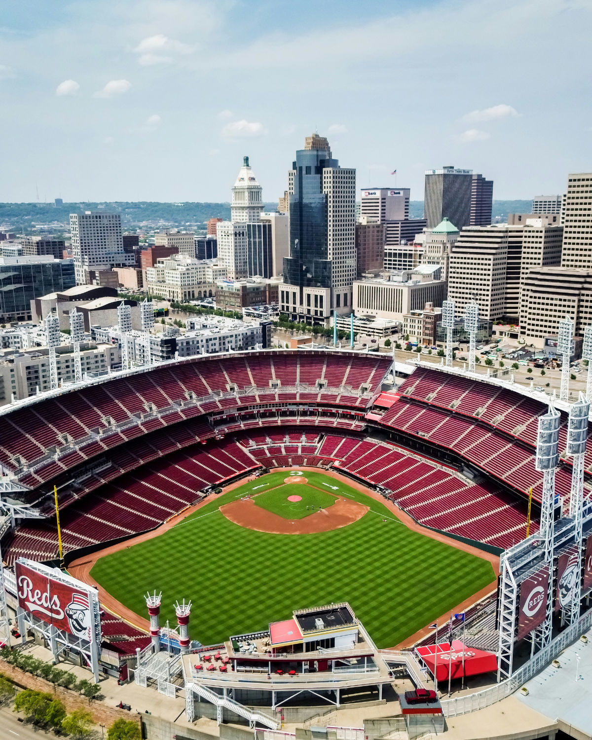 Aerial view of Great American Ball Park in Cincinnati, Ohio with the iconic red seats and the Ohio River and Kentucky hills in the background
