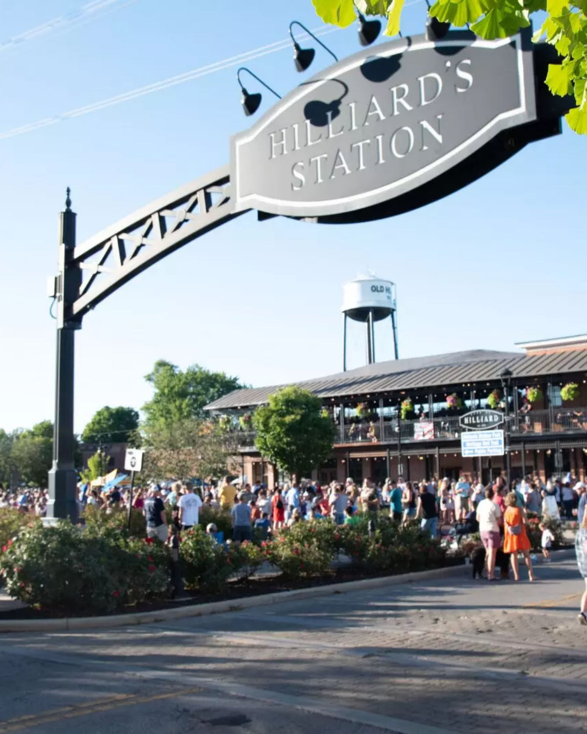 Lively outdoor gathering at Hilliard's Station Park with crowds enjoying shops, restaurants, and community events in downtown Hilliard, OH
