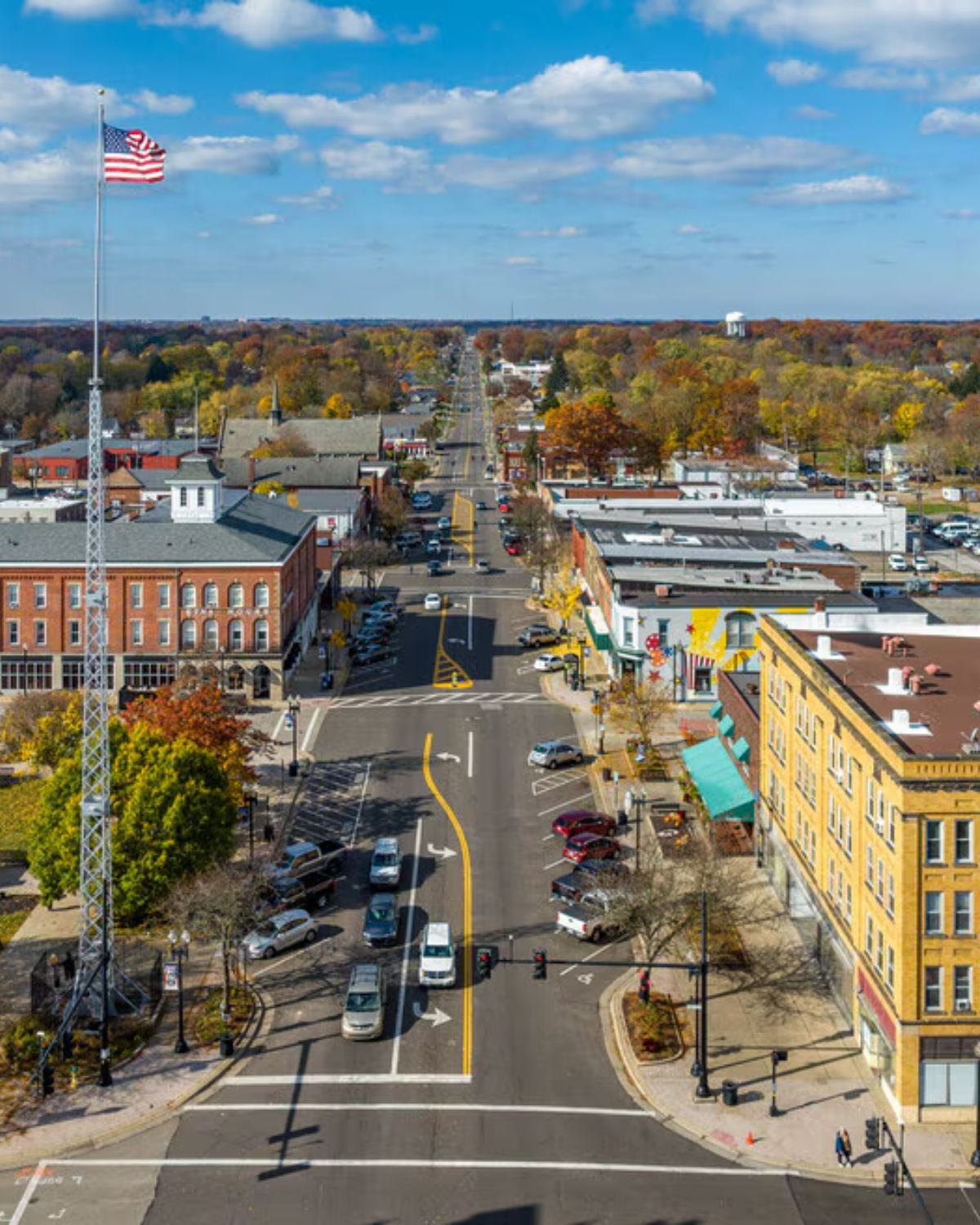 Aerial view of charming downtown Ravenna, Ohio with colorful historic brick buildings, tree-lined streets, and a vibrant small-city streetscape