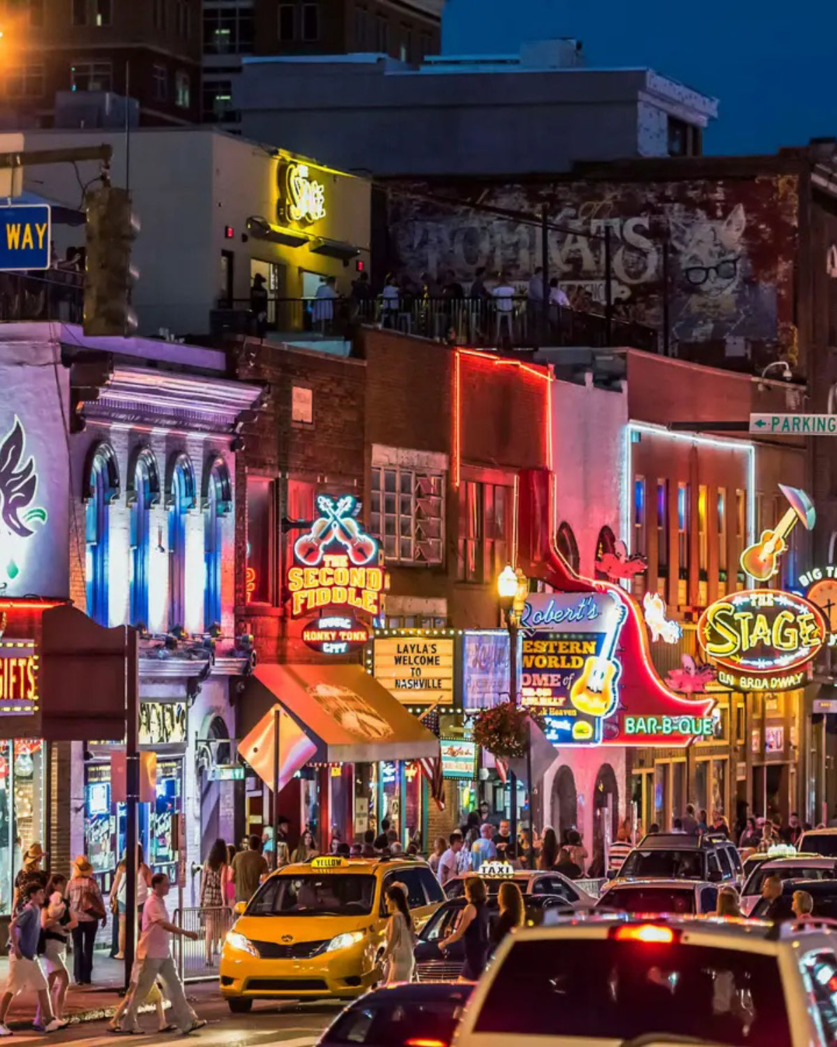 A busy street view of Downtown Broadway bars and restaurants in Nashville, TN