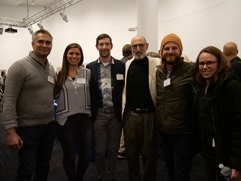 Professor Emeritus Steve Rost stands in a group photo with his former students at his retirement celebration in the UTLC Gallery.