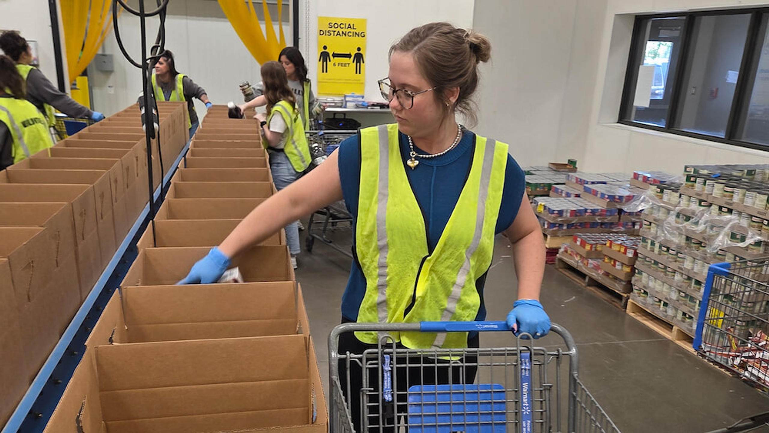 staff member smiling with cart