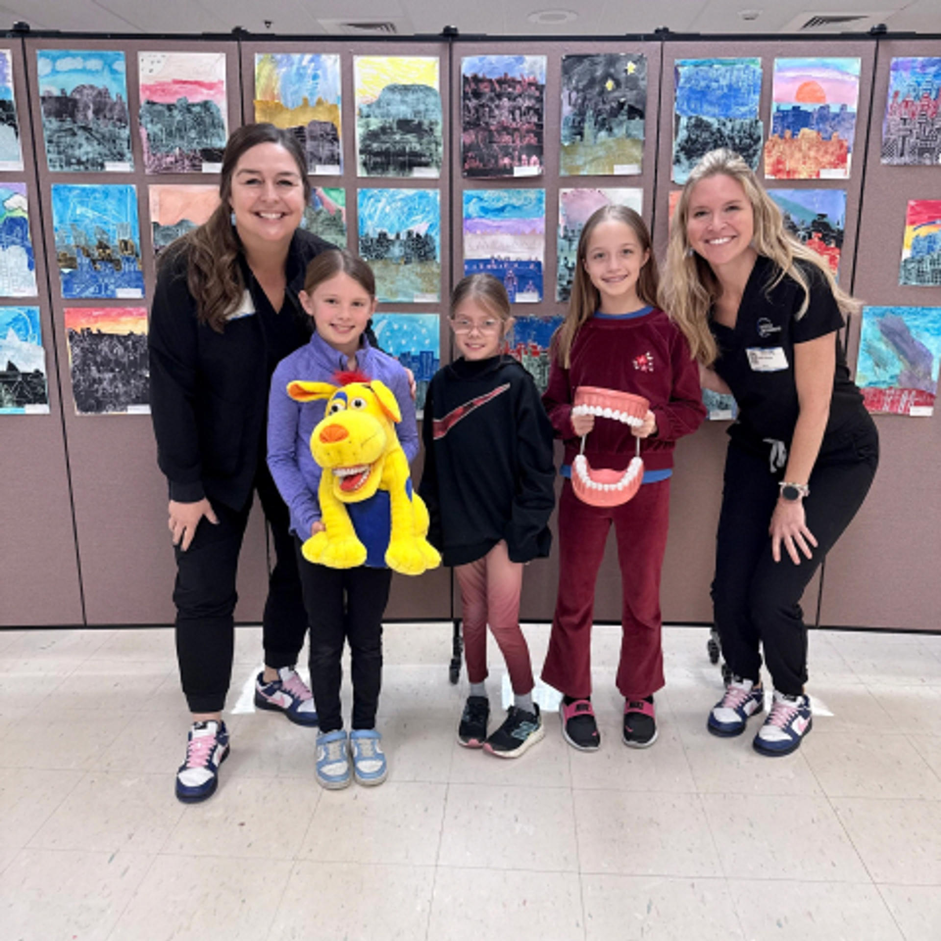 dr Doyle with an employee and some young patients