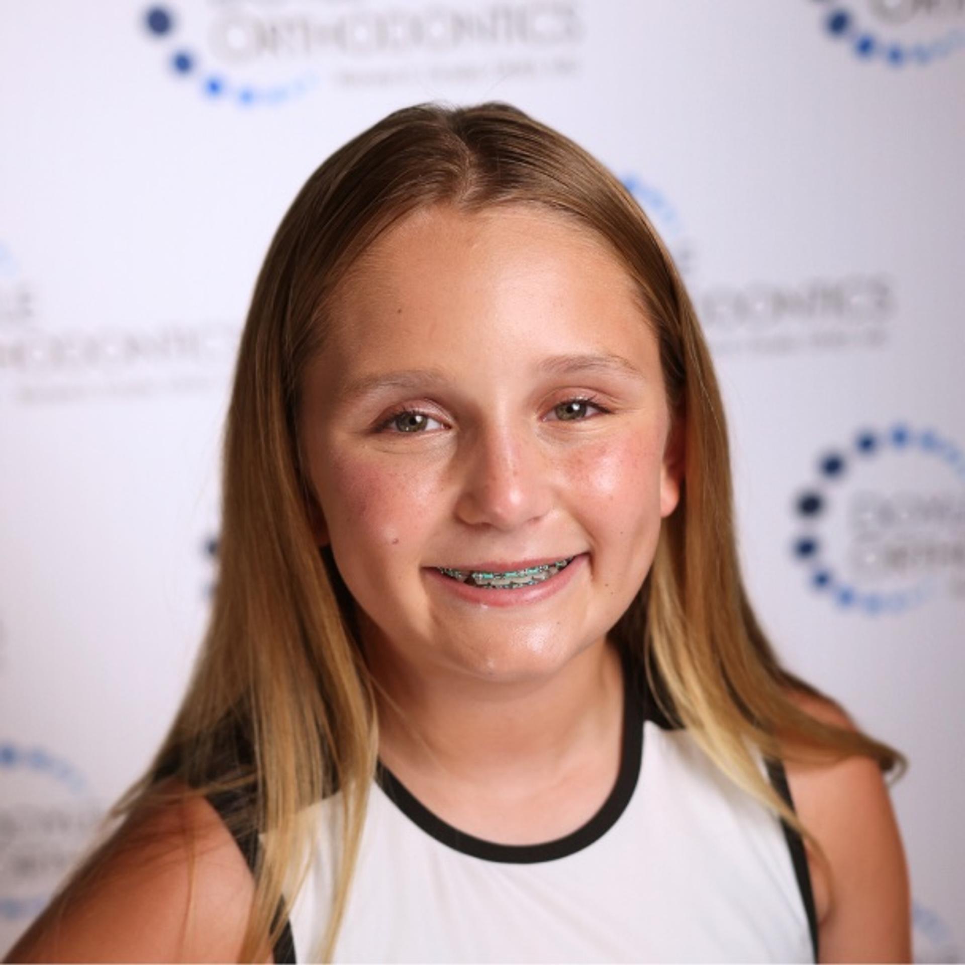smiling teen girl in sports uniform