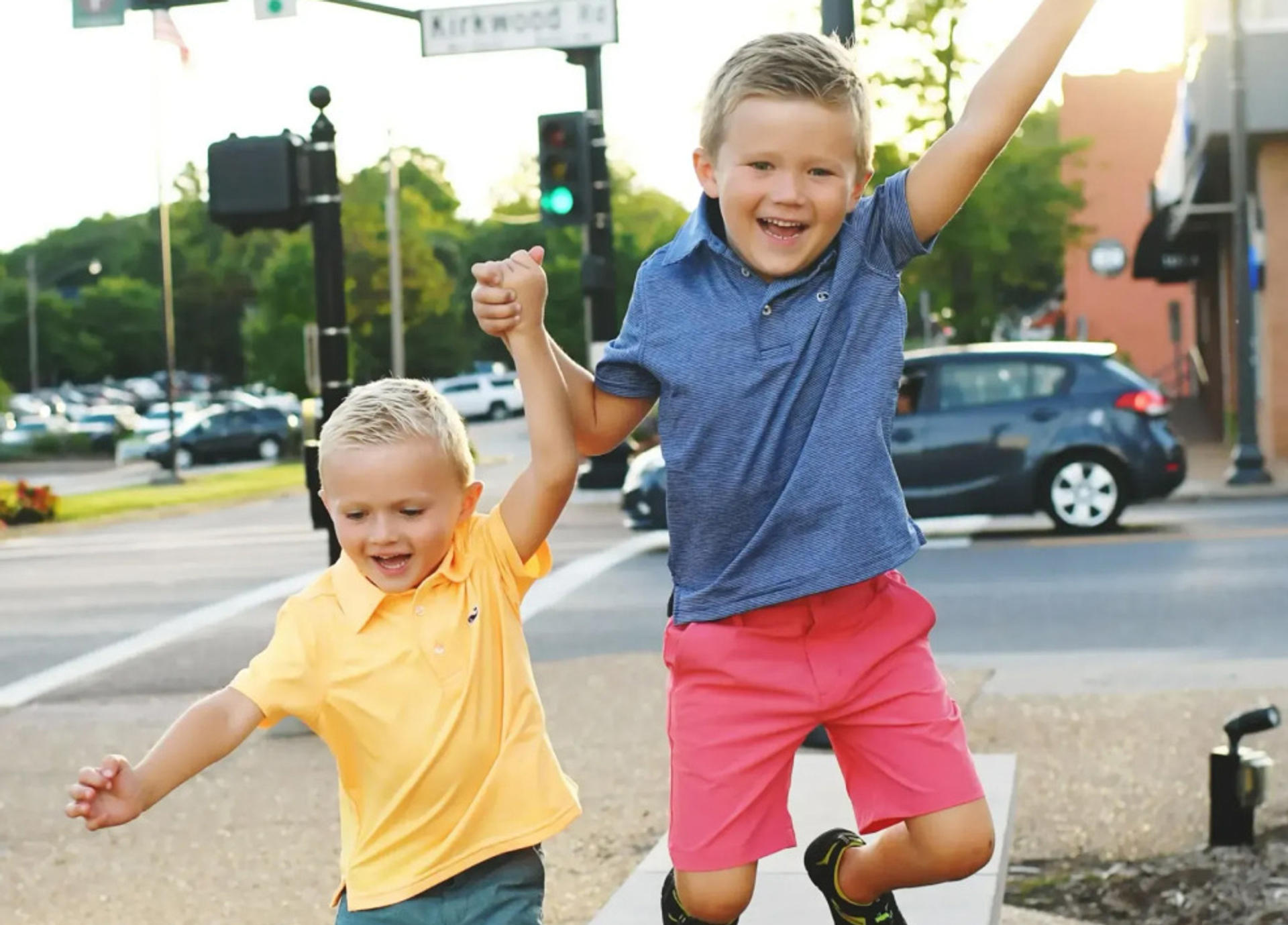 two kids jumping outside