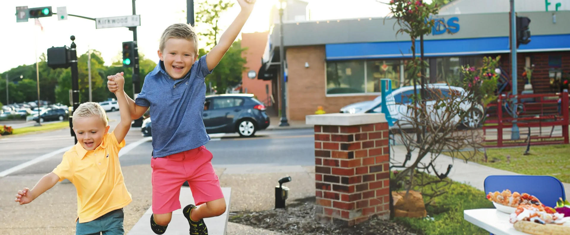 two kids jumping outside