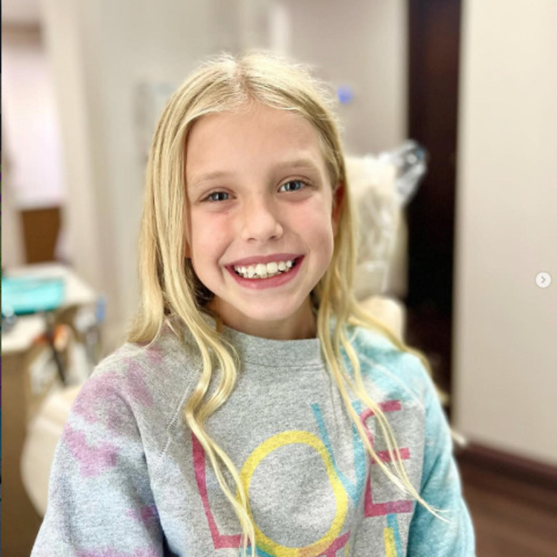 a smiling girl with blonde hair