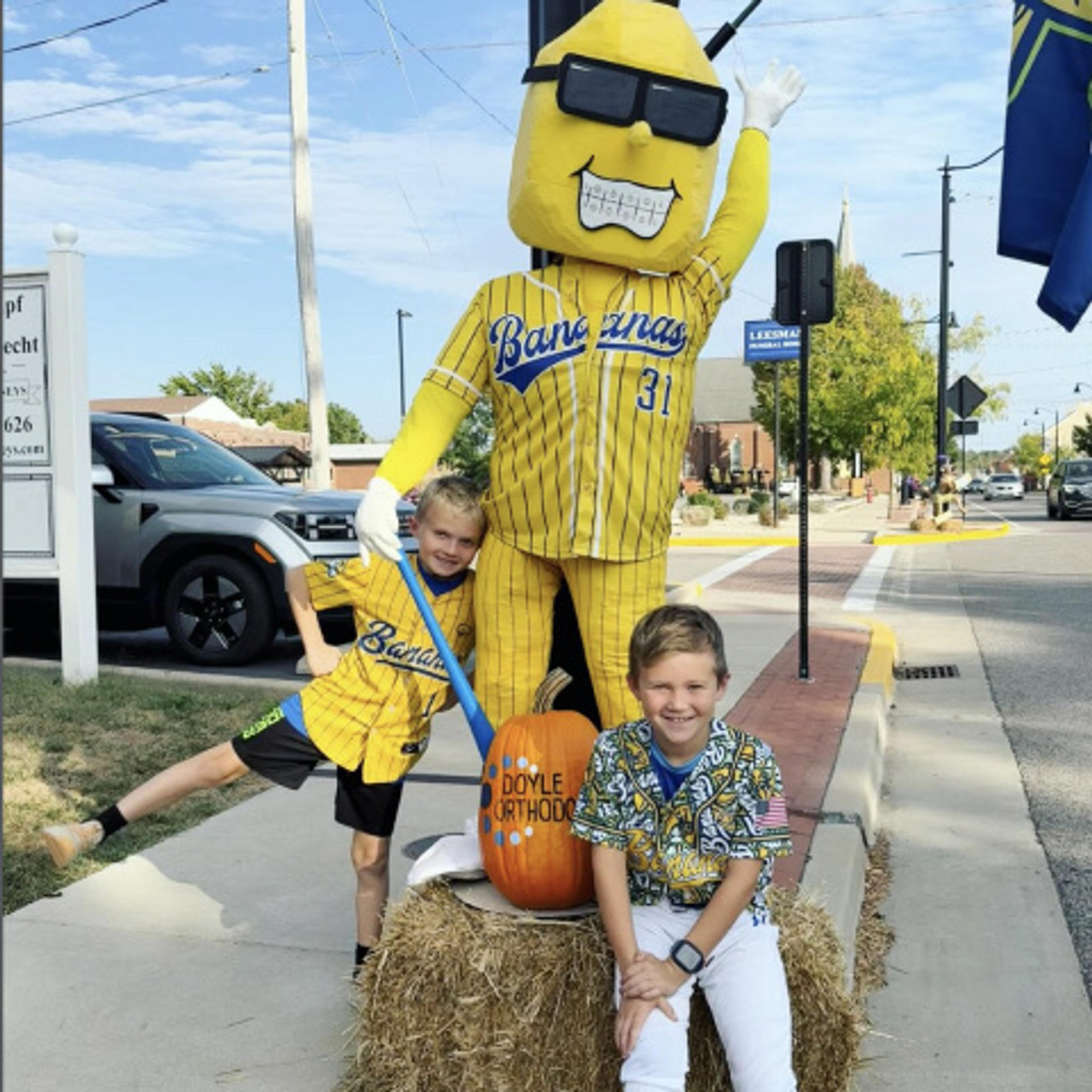 two kids with the Savannah Bananas mascot
