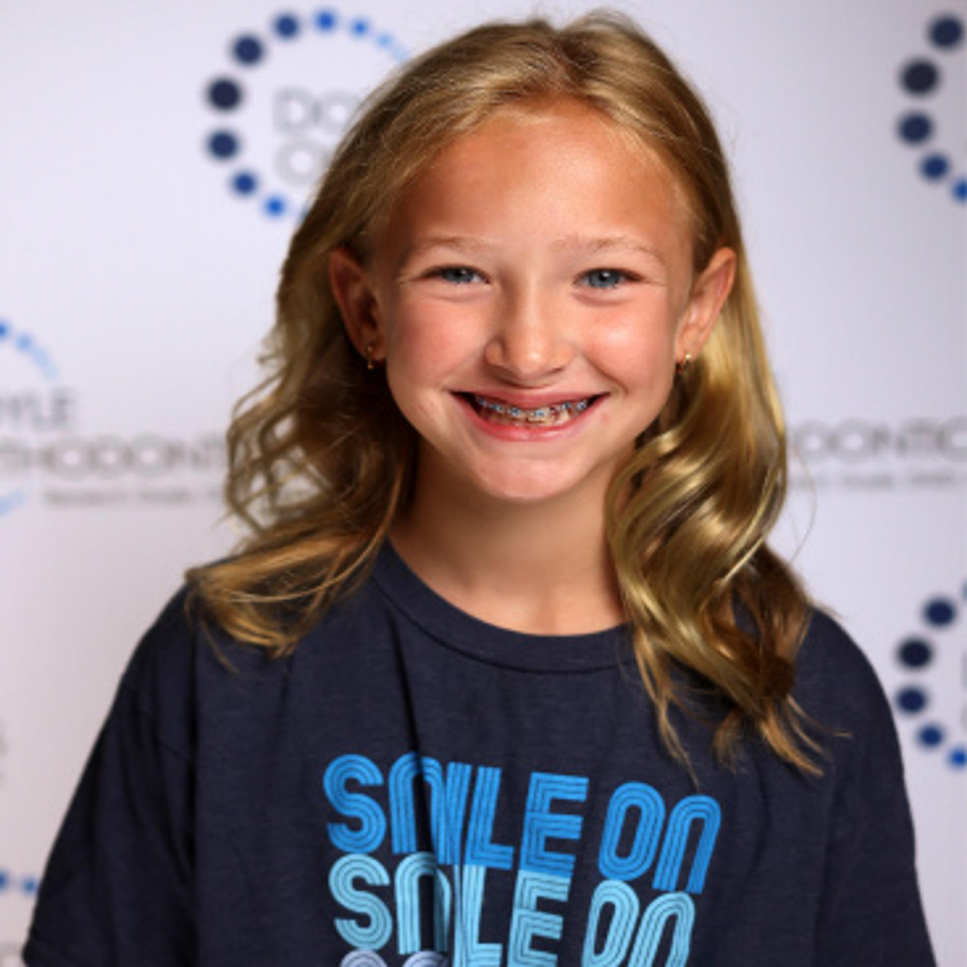 a smiling adolescent girl with braces