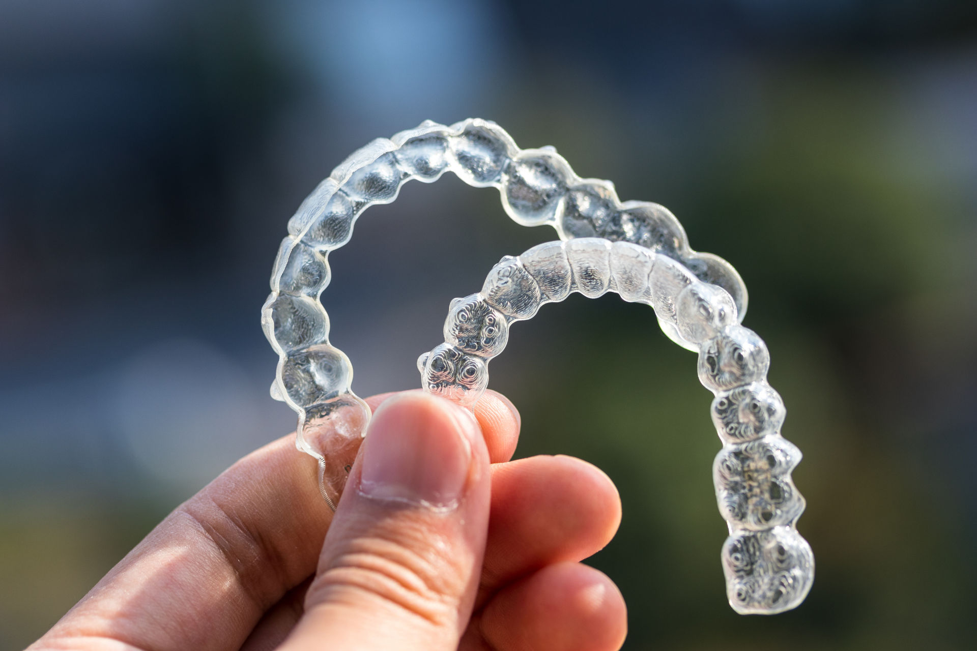 patient holding invisalign trays