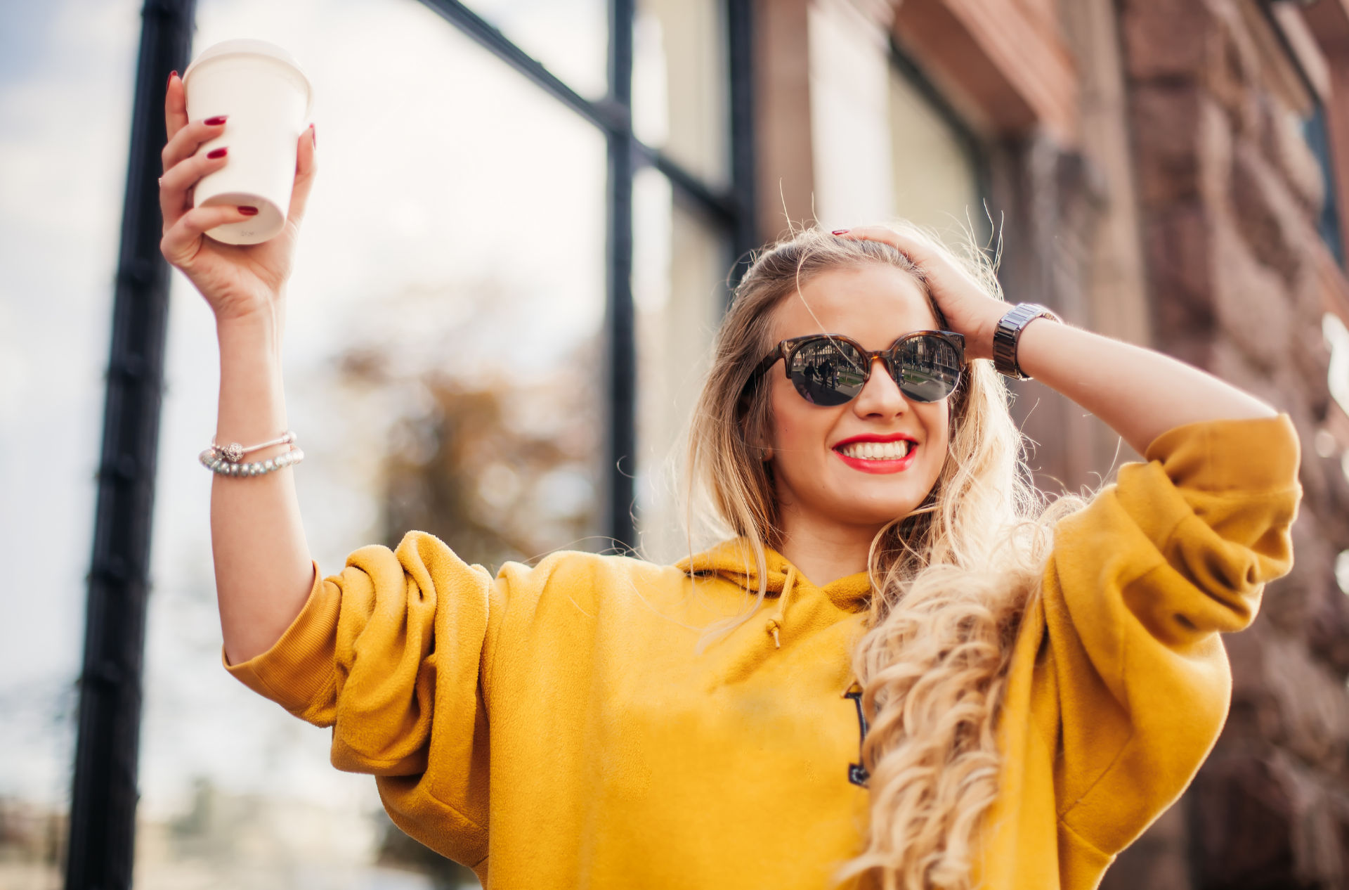 girl drinking coffee with Invisalign aligners