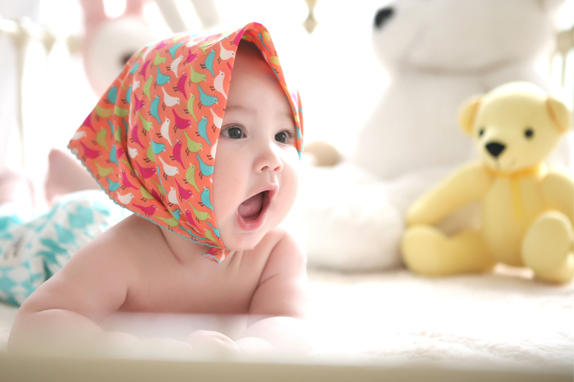 adorable baby with a yellow bear