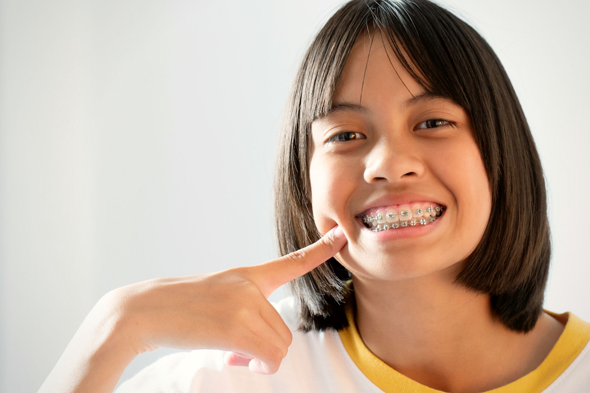 kid with blue braces and missing teeth