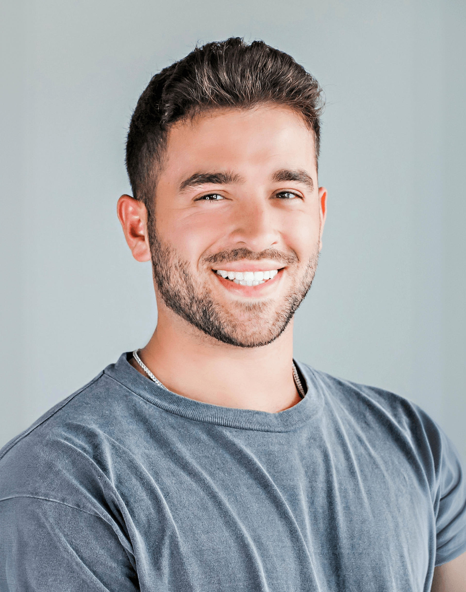 Smiling adult man wearing Invisalign clear aligners