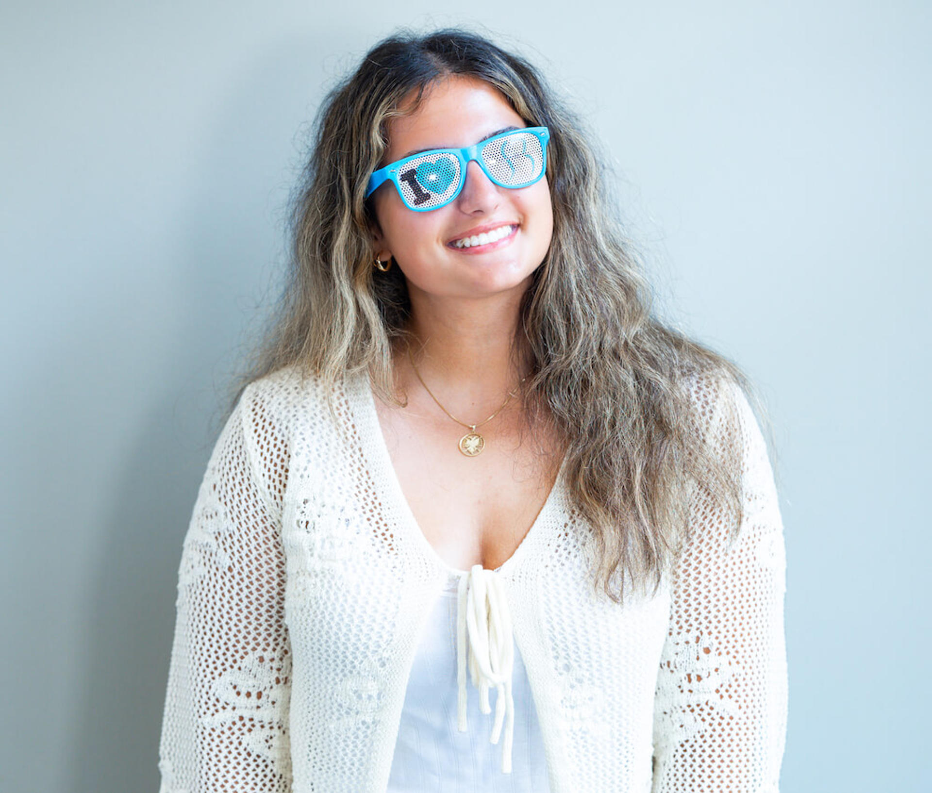 smiling teen girl with reynolds orthodontics branded glasses