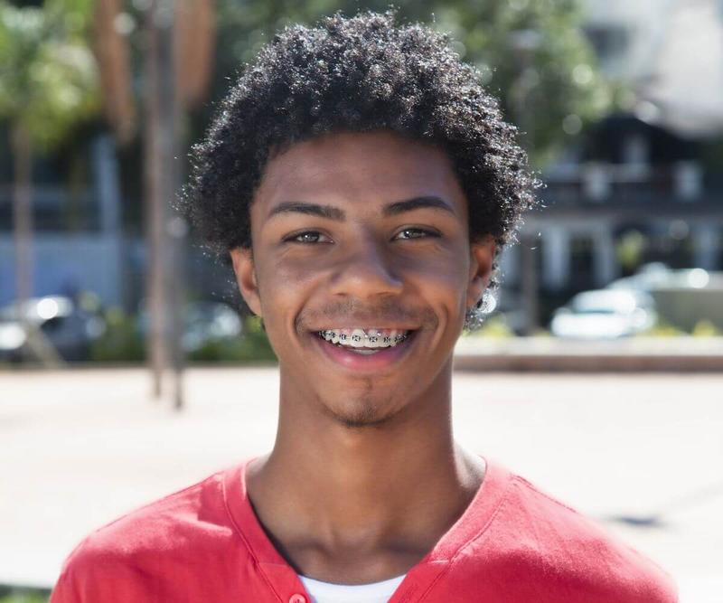 Young man smiling with braces