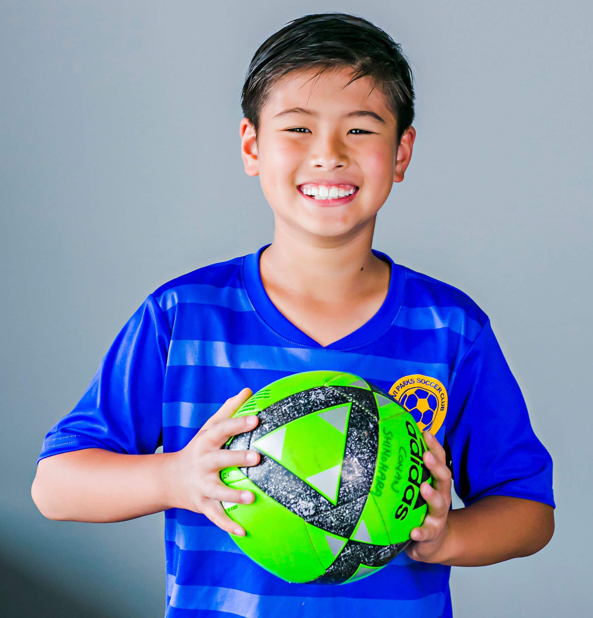 smiling boy holding soccer ball
