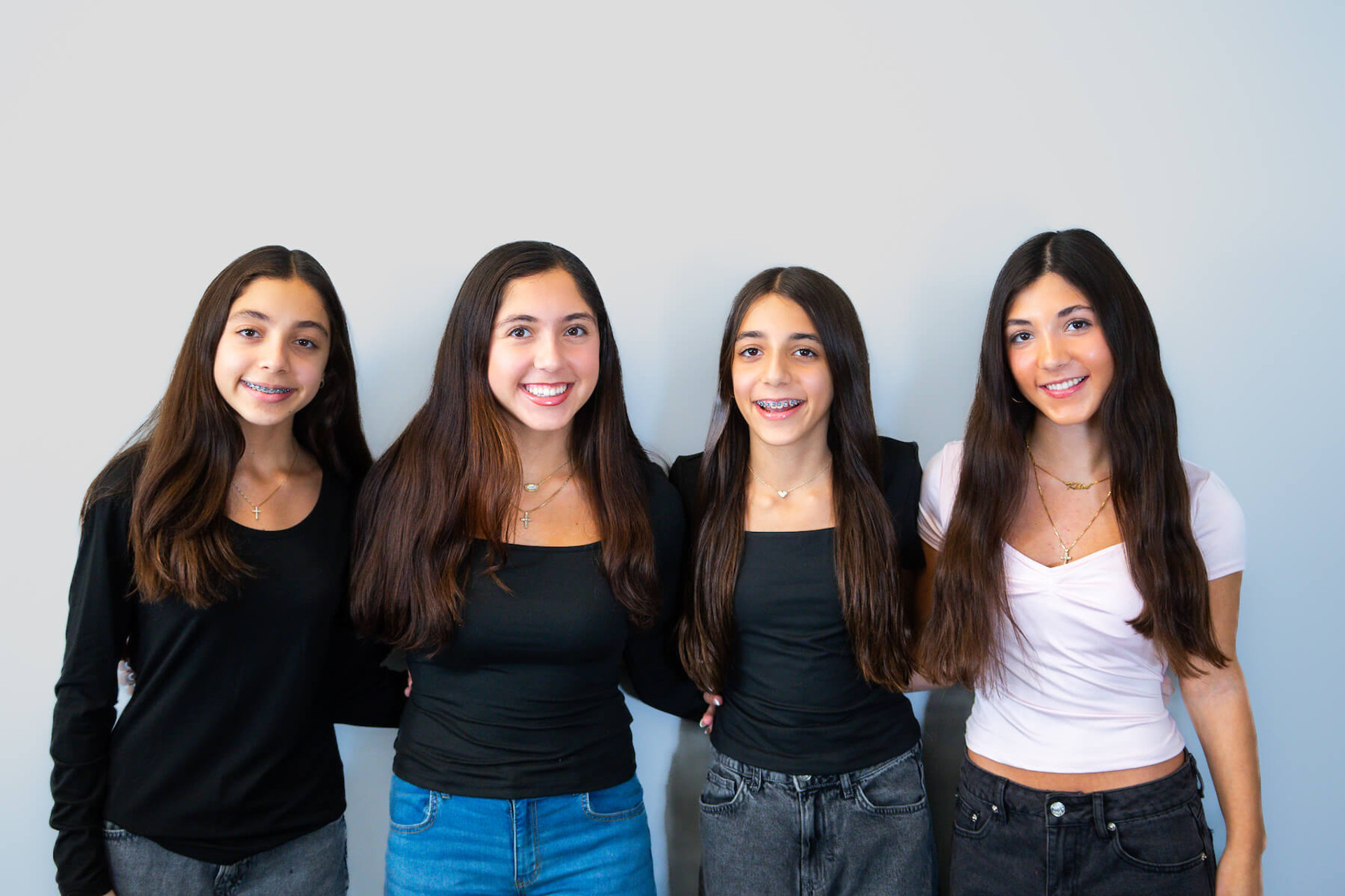 four smiling teenage girls