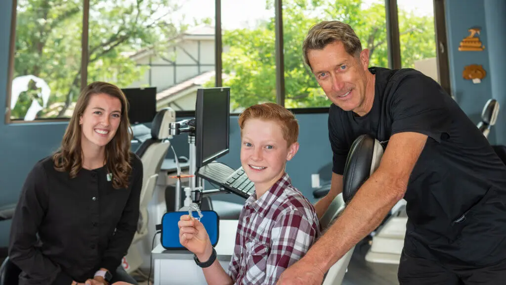 Dr. Dietmeier with teenage patients smiling