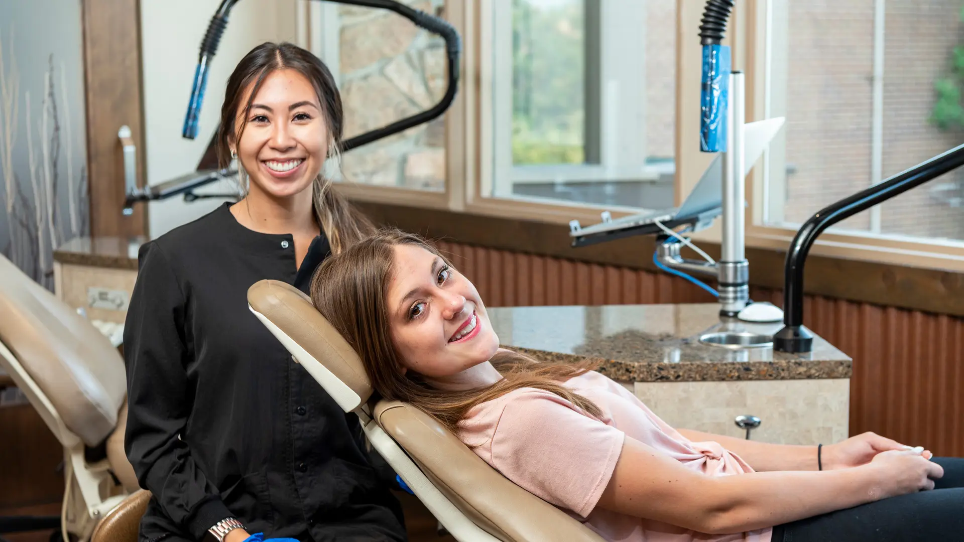 young patient with team member throwing peace signs