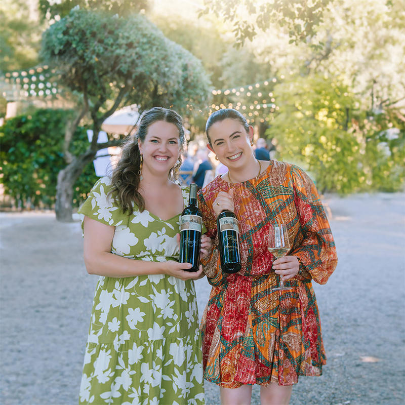 Two woman enjoying a Plumpjack Estate Winery tasting event.