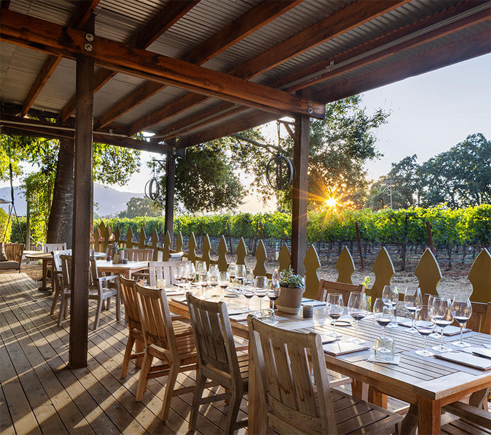Large table overlooking Plumpjack Estate Winery.