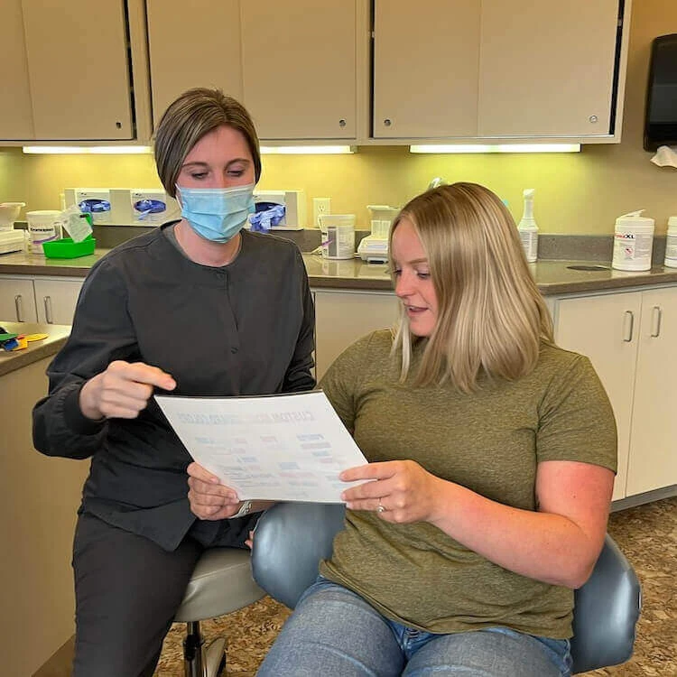dental assistant guiding patient
