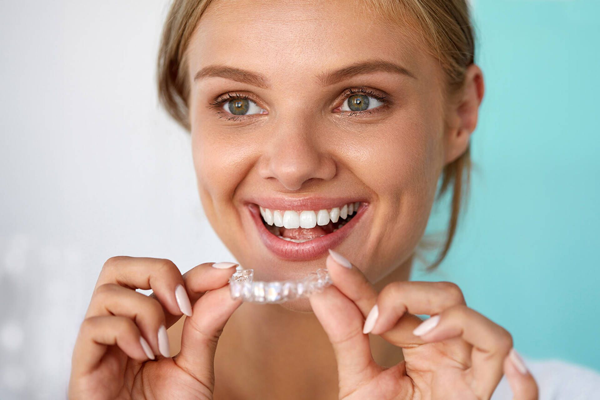 Smiling Woman With Beautiful Smile Using Teeth Whitening Tray. High Resolution Image