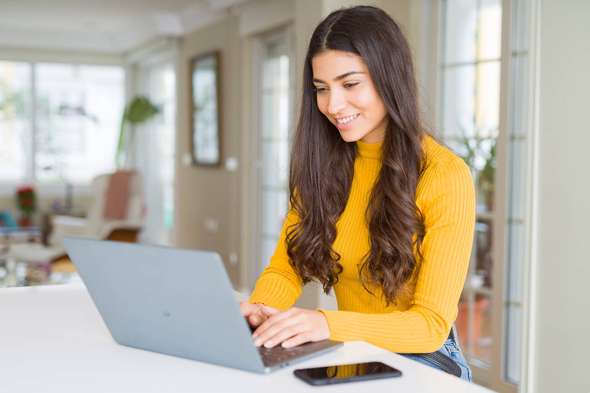 Beauitul young woman working using computer laptop concentrated and smiling