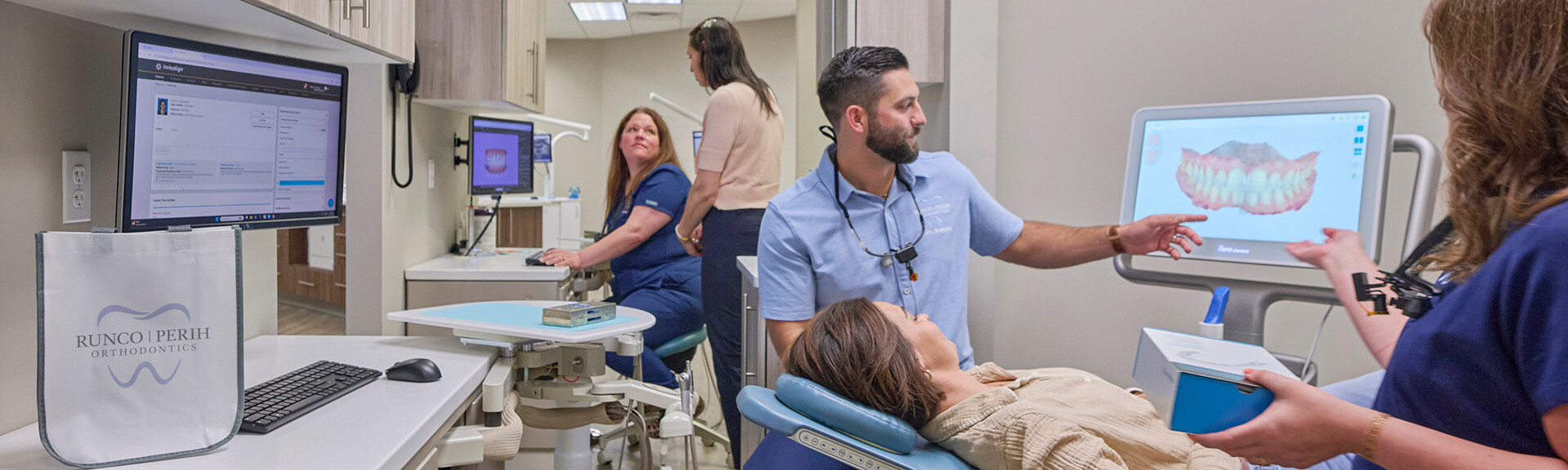 Image of smiling woman sitting in dental chair while professional doctor fixing her teeth