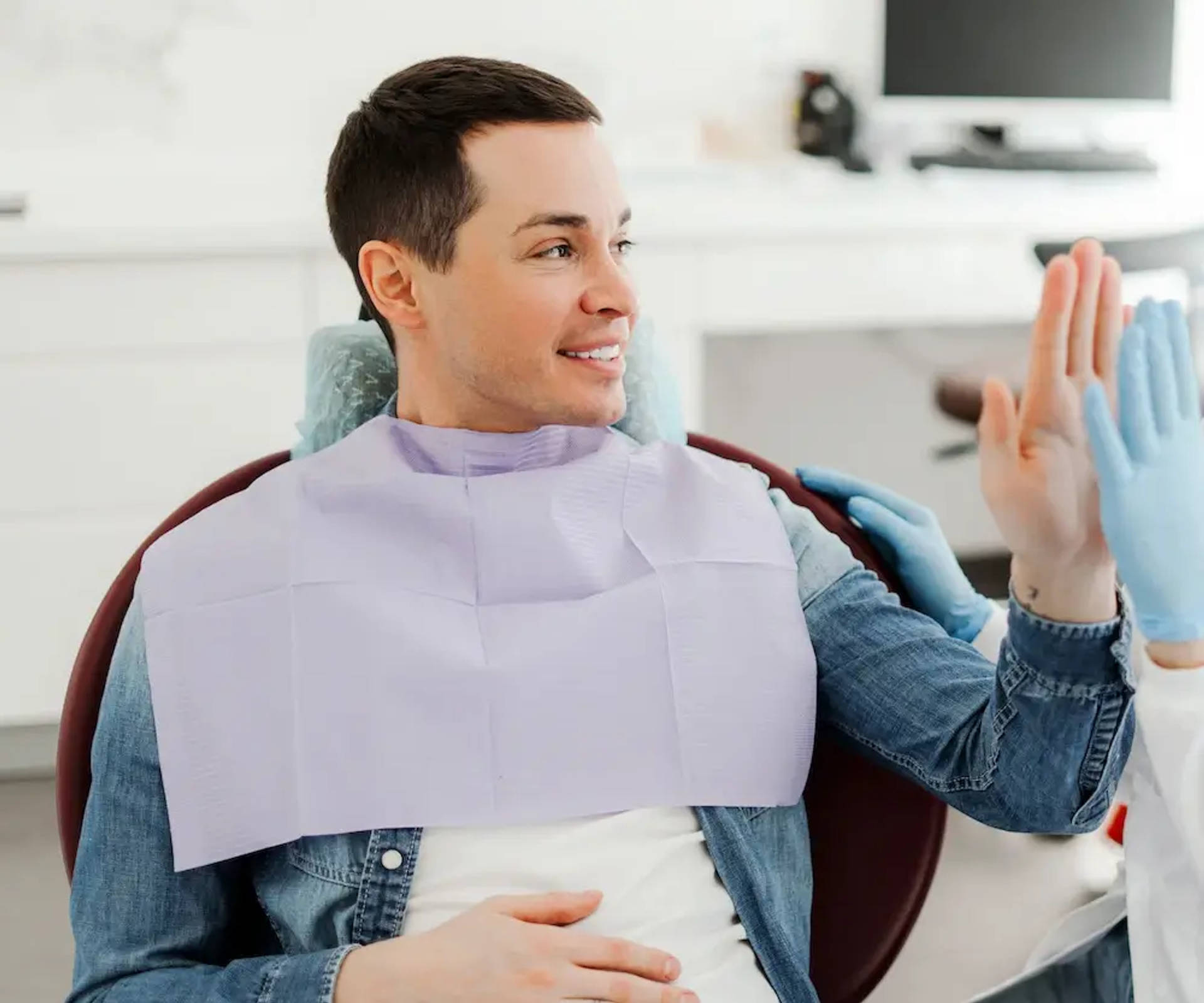 man giving high five to orthodontist