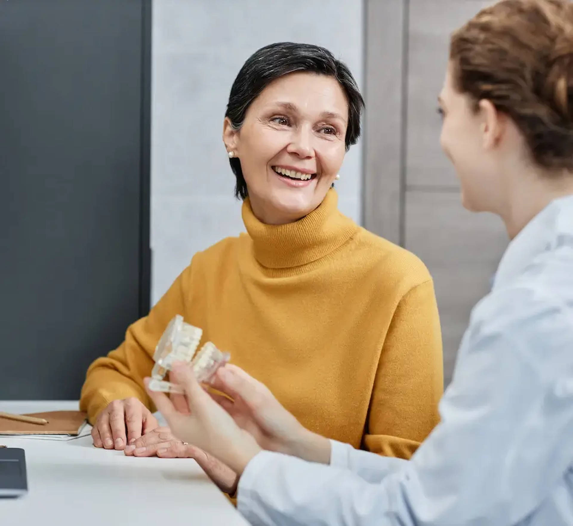 woman speaking with orthodontist