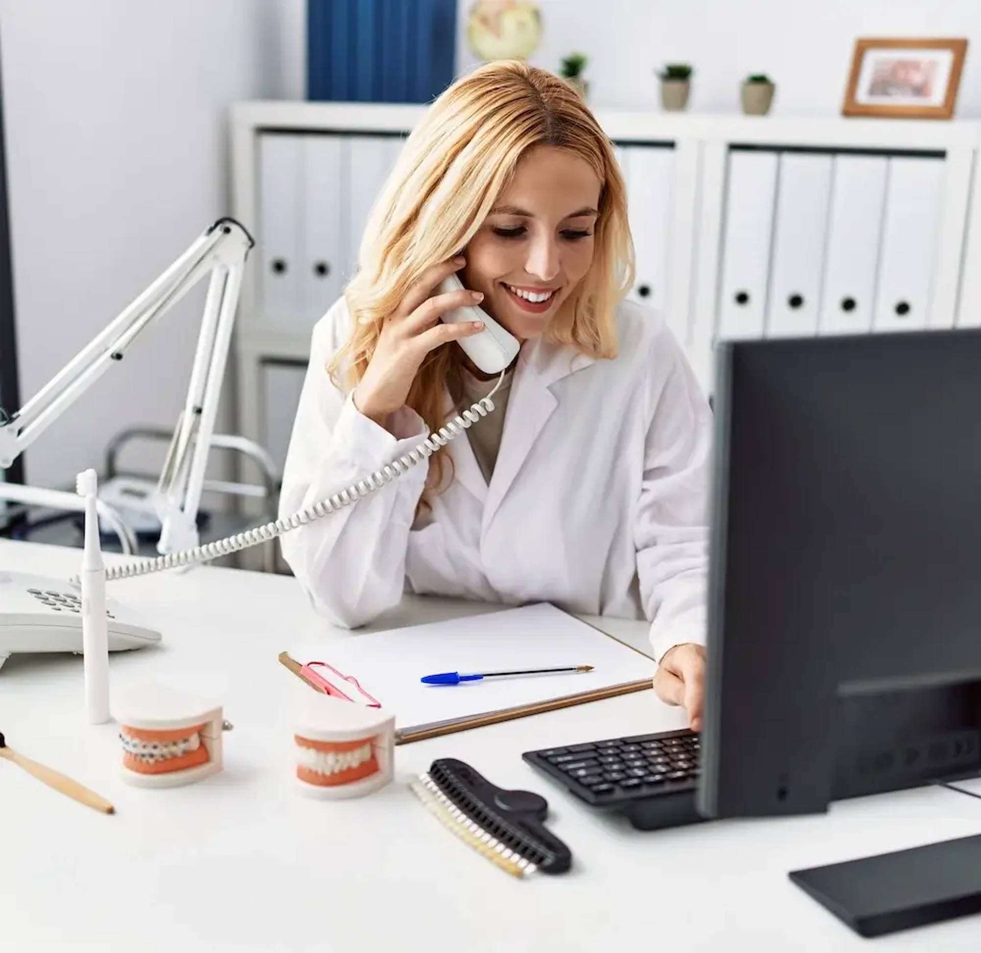 orthodontist on phone and computer