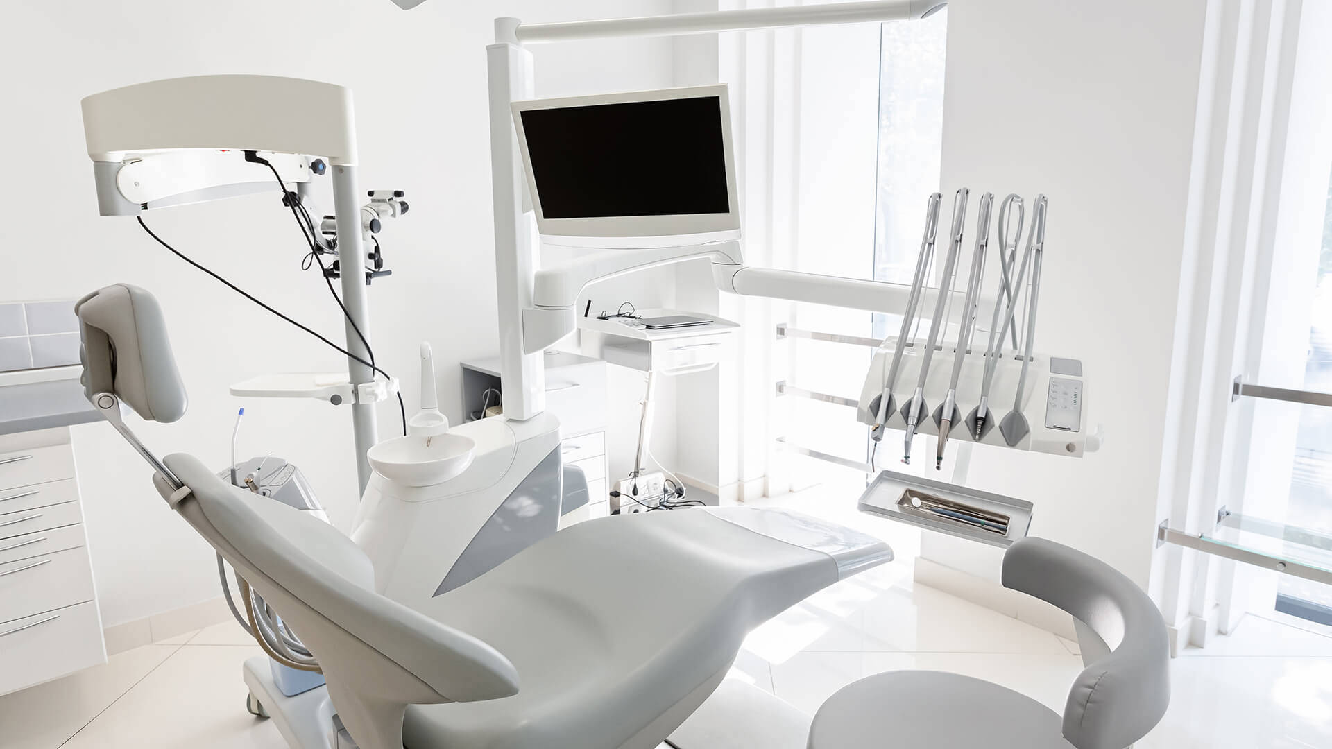 Modern empty dental chair with dental equipment