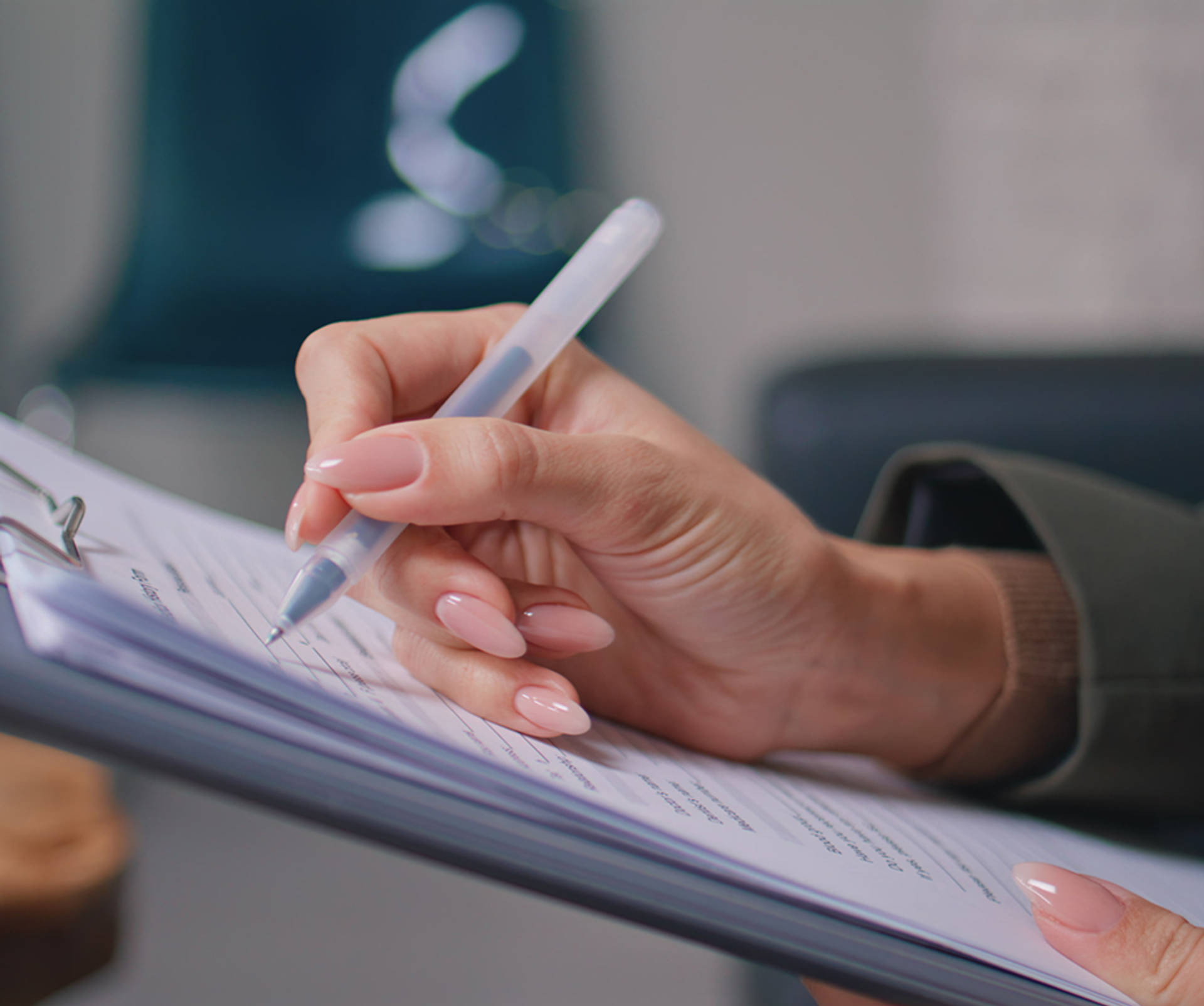 a hand filling out Patient Forms