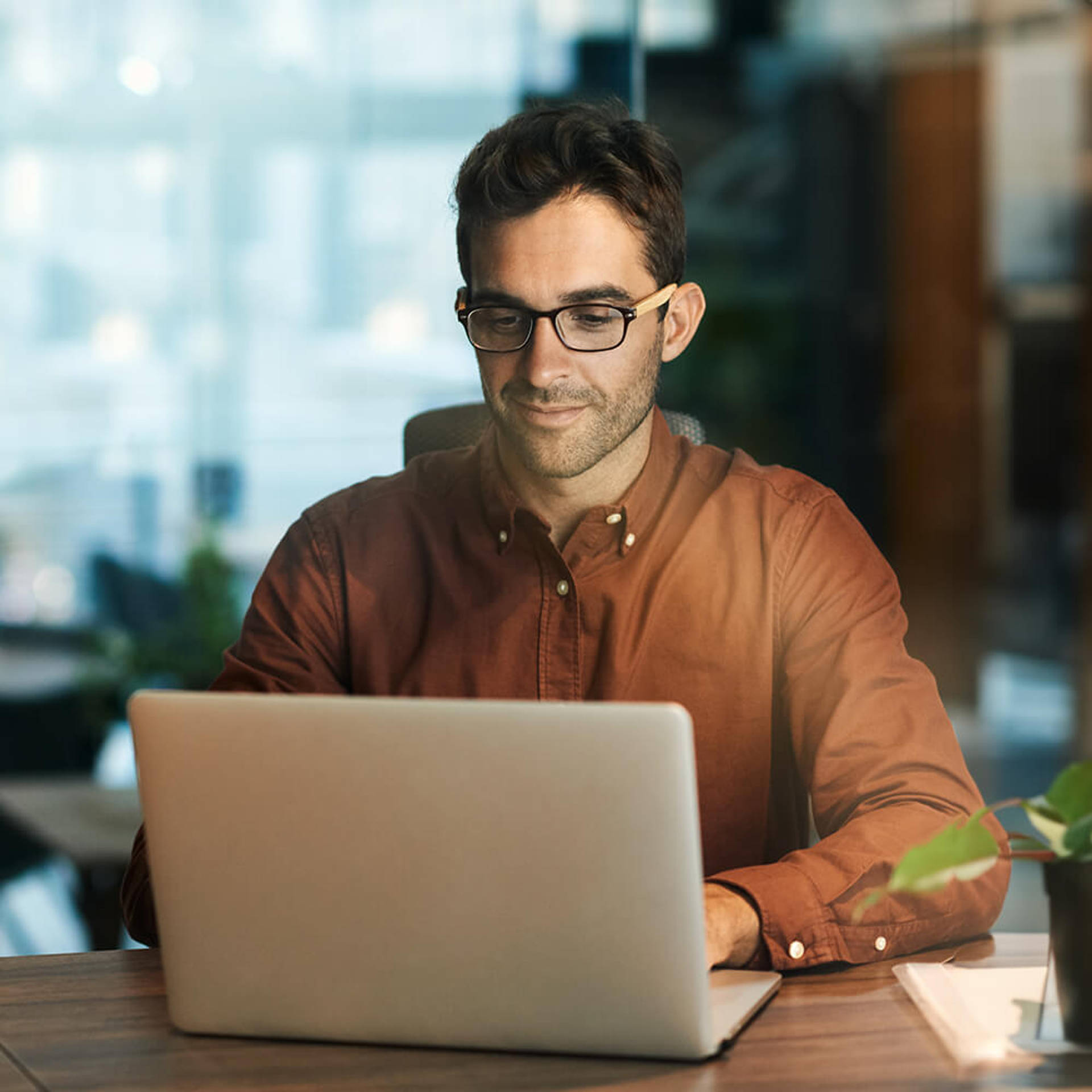 Businessman using a laptop while working late in his office