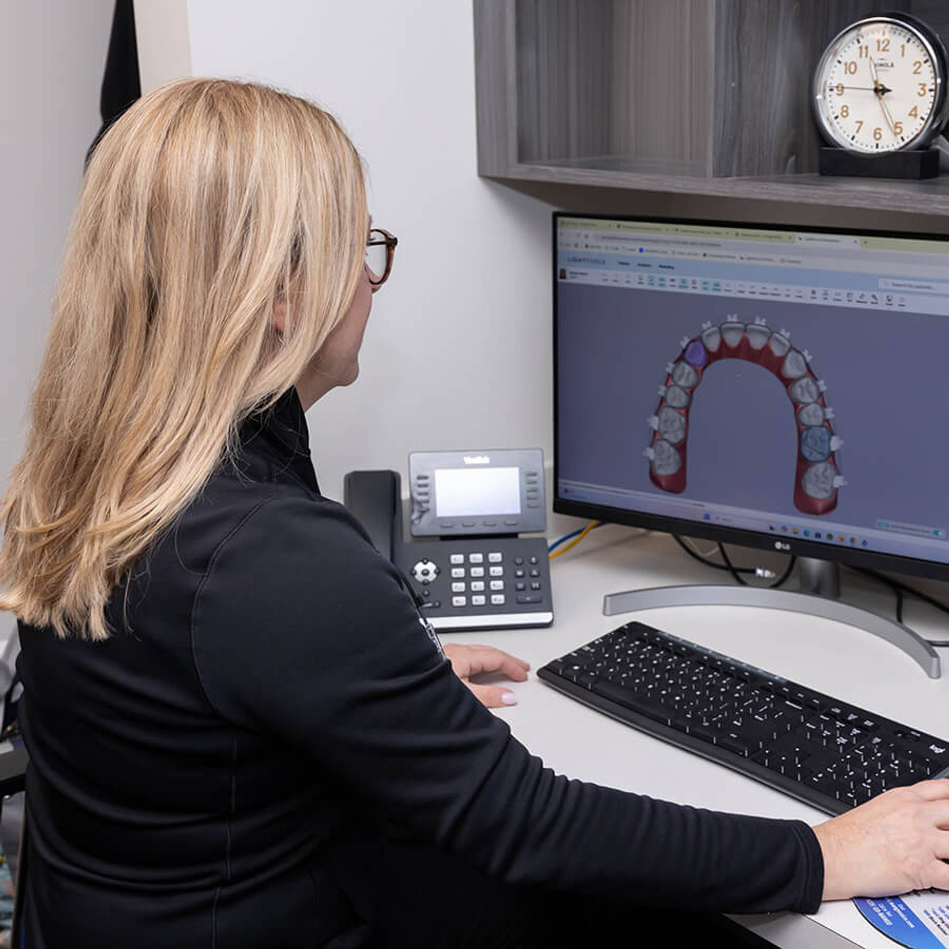 Dr. Nakisher looking at braces model on computer