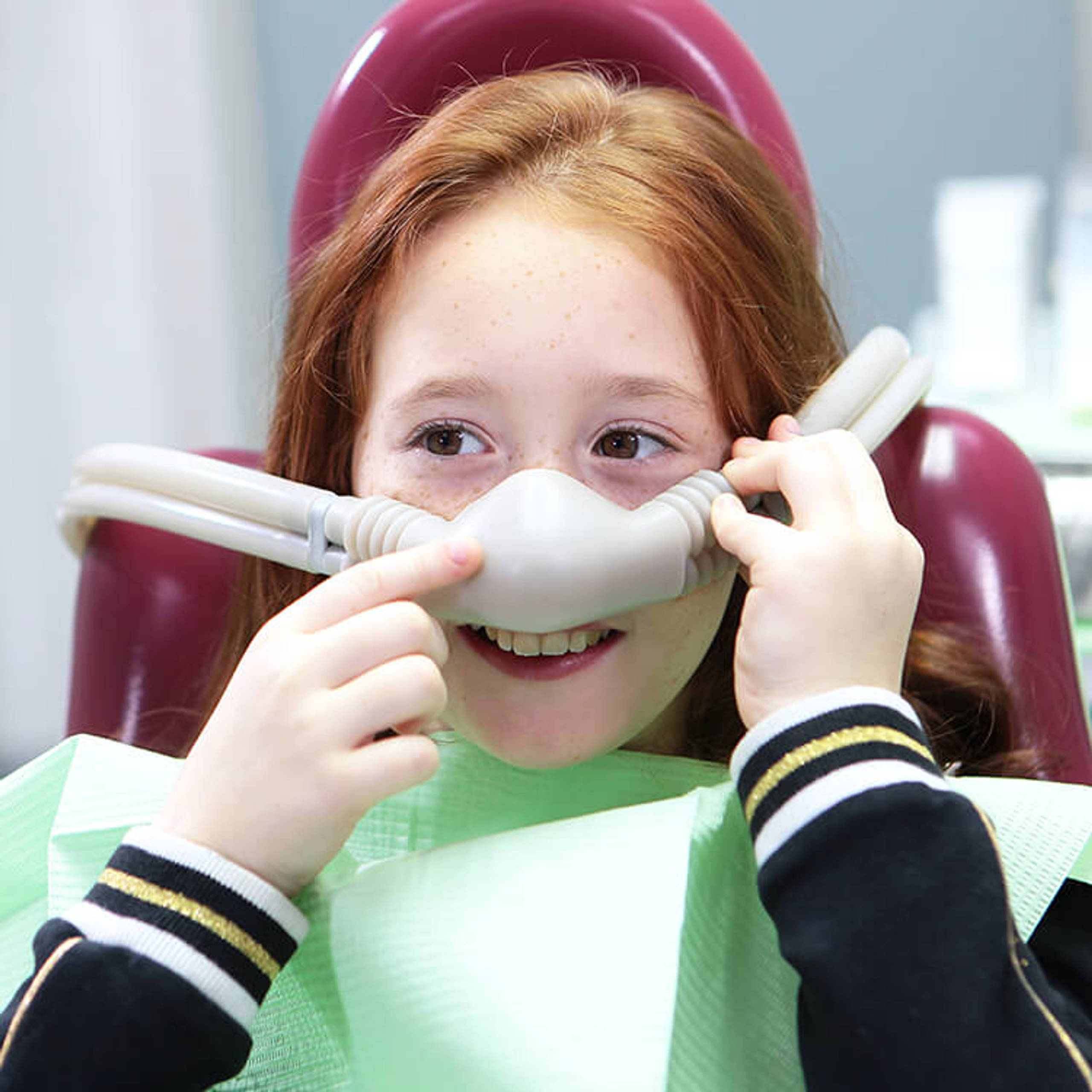 Little girl with sedation mask. Treatment of children's teeth with nitrous oxide. Children's dentistry. Anesthesia for children in dental treatment. 