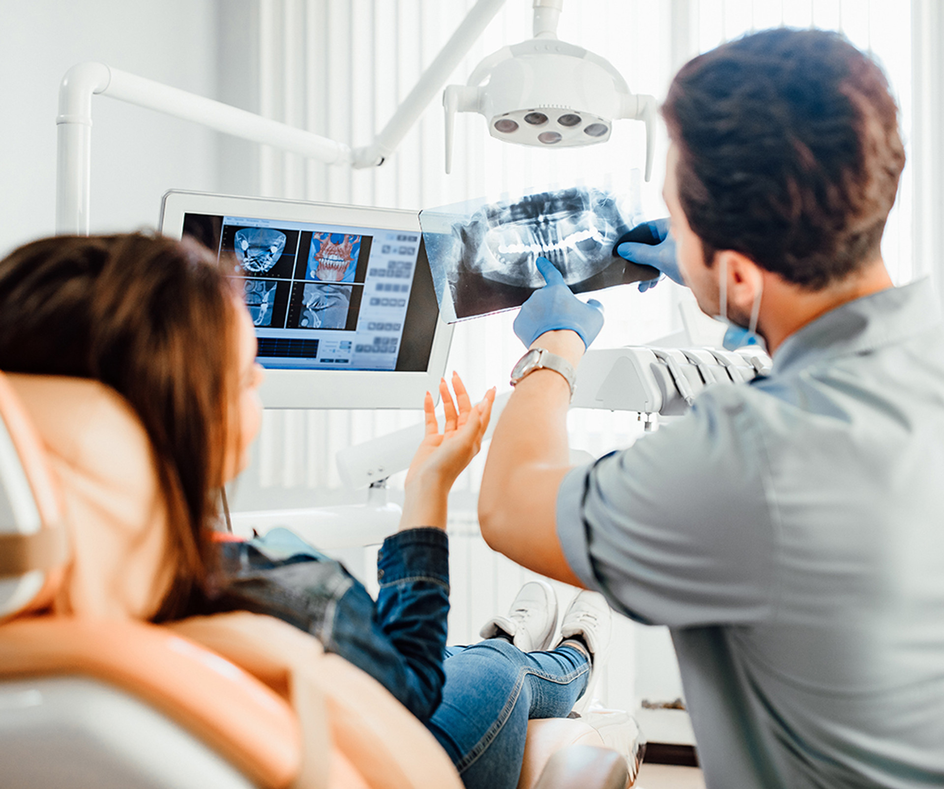 a doctor and patient looking at x-rays of teeth